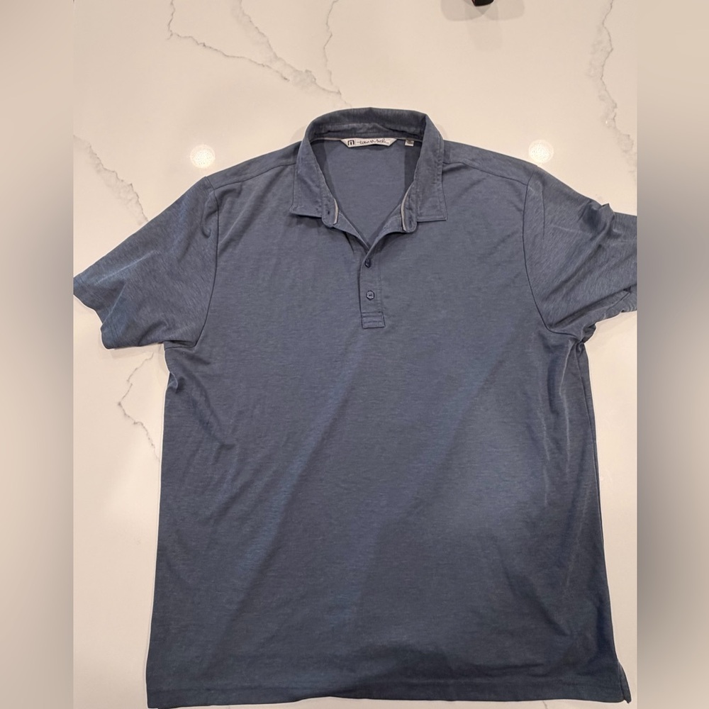 Travis Mathew’s men’s blue polo